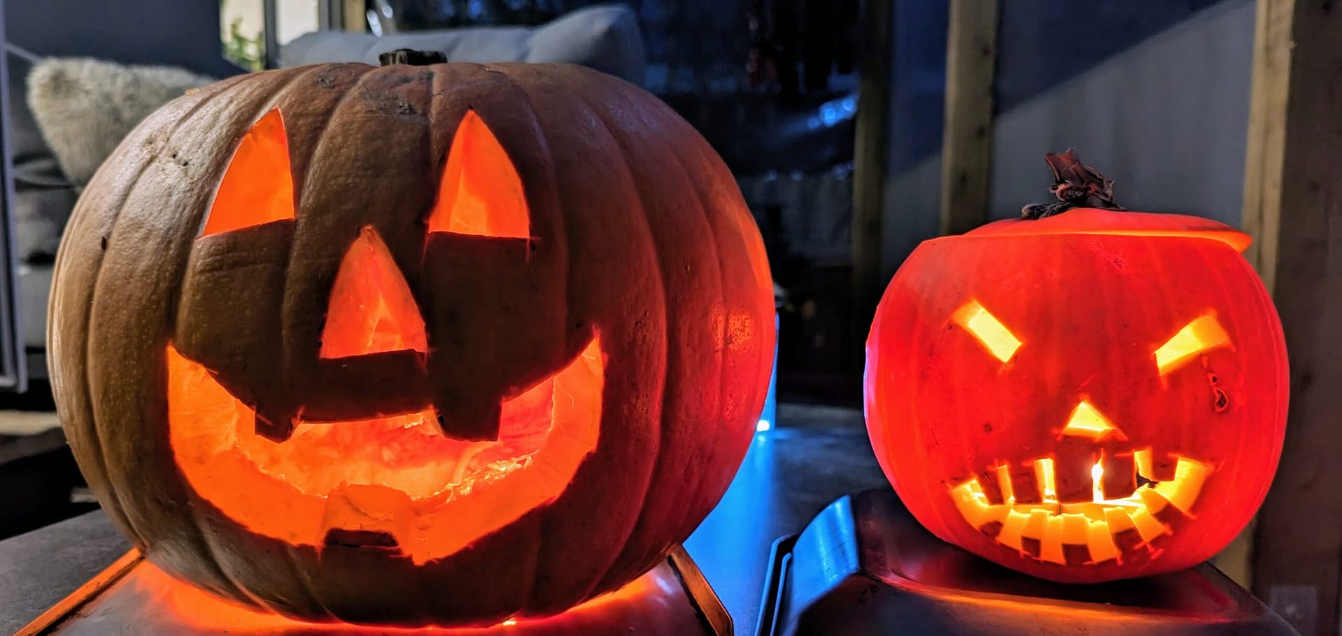 lights shining inside pumpkins at Halloween
